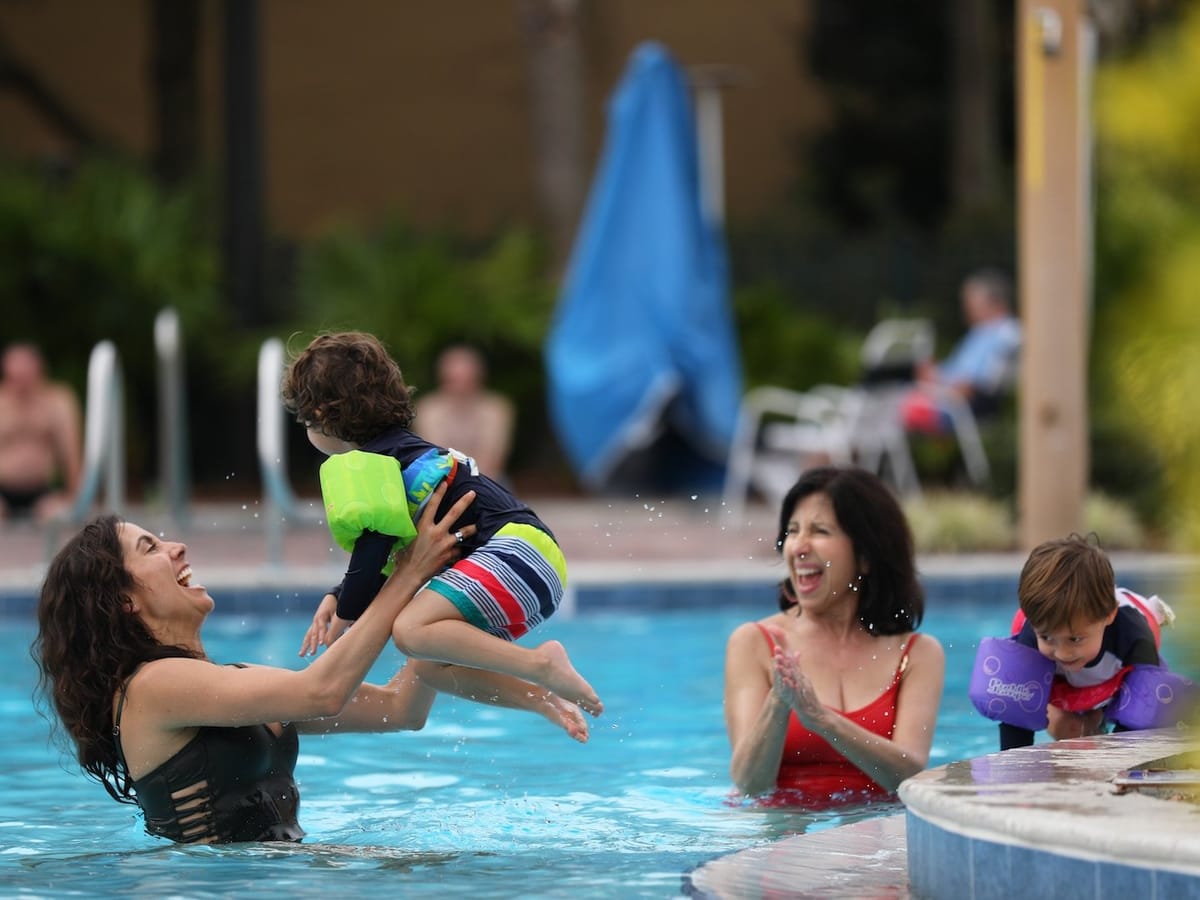 Family enjoying outdoor pool.